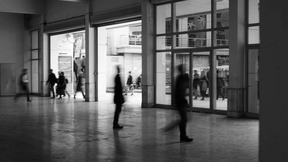 Public building hallway with rushing people